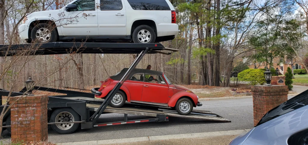 Open car trailer loading a sedan in Denver